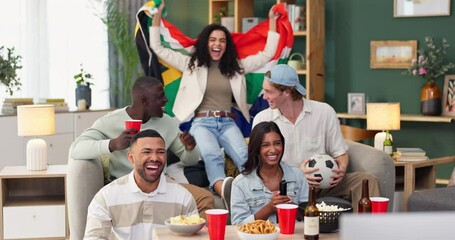 Group, people and celebration on sofa watching tv for soccer, world cup or event in living room. South African flag, diversity and friends with alcohol, happiness or goal from football team in home