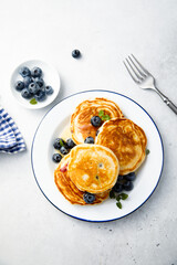 Homemade pancakes with blueberries and honey