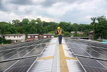 Fototapeta premium A solar panel installation company employee assembles a photovoltaic system on the roof.