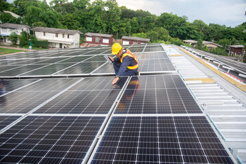 A solar panel installation company employee assembles a photovoltaic system on the roof. © sirisakboakaew