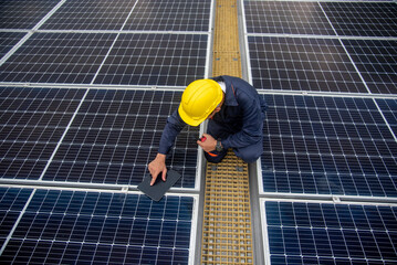 Workers installing solar panels are building a photovoltaic system on the roof.