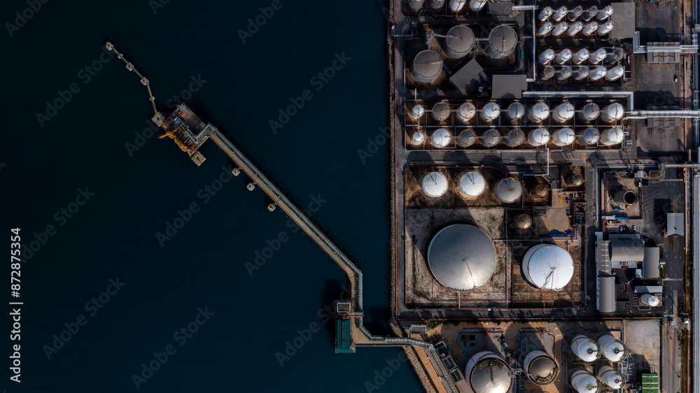 Wall mural Aerial view oil and gas depot industrial facility for storage logistic petrochemical product, Crude oil and gas depot terminal storage tank petroleum petrochemical refinery product, Business energy.