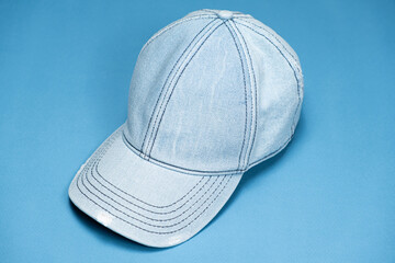 Blue denim cap close-up on blue background.