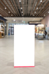 A blank billboard stands in a shopping mall.
