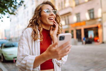 Young woman tourist walking around the street, making selfie, communication with friends. Networks, blogging, online shopping concept