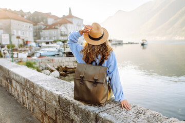 Back view of Tourist woman on the observation deck admiring view of colorful the view of the city...