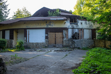 Abandoned building in ruins in a park or forest, obsolete structure , abstract element