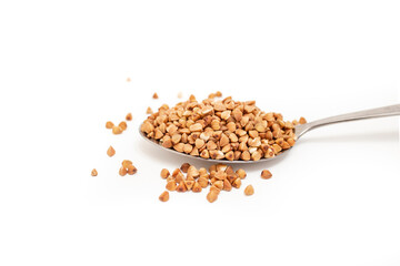 Buckwheat seeds pile in a stainless steel spoon isolated on white background