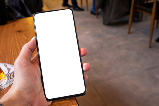 Hand holding blank screen smartphone at the cafe, mockup phone, transparent background png