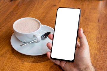 Hand holding blank screen smartphone at the cafe, mockup phone, transparent background png