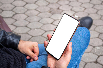 Hand holding blank screen smartphone at the outdoor, mockup phone, transparent background png