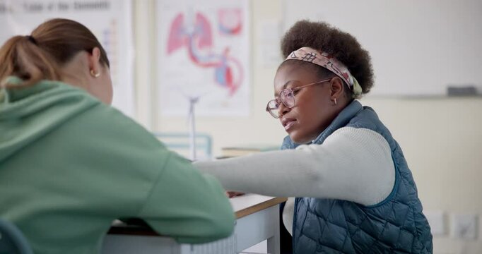 Teacher, woman and girl for advice at high school in consultation, results or review for progress. Mentor, people and student with book for help, study or learning for project in classroom at academy