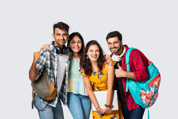 Asian Indian smart college students posing for a photo against white background