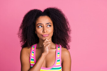 Portrait of unsure girl with curly hairstyle wear colorful top thoughtfully look at logo empty...