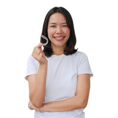close up young beautiful asian woman smiling with hand holding dental aligner retainer (invisible)...
