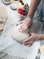 Woman baker shaping the dough.
