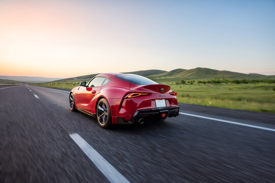 Seattle, Washington, USA, July 01, 2024, Red Toyota Supra 2020. car on the highway road. Sports car concept. back view