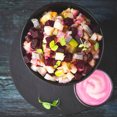 Rosolje - Estonian beet and herring salad or Rosoli Finland salad with boiled beets, potatoes, apples, onions,  herring fish. Midsummer festive food. Slavic, Scandinavia recipes, rustic style
