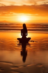 Fototapeta premium Woman Meditating on Beach at Sunset