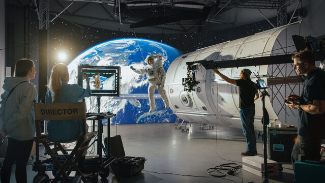 Successful Female Director Leads a Professional Crew Filming a Sci-fi Movie With Advanced Cgi, Featuring an Astronaut on a Futuristic Set With Immersive Space Visuals.