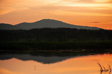 Obraz premium evening view of mountains covered with forest, beautiful sunset