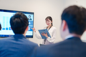 リモート会議でプレゼンをする若い女性社員