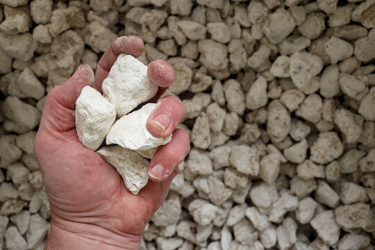 Magnesite (magnesium carbonate, MgCO3) ore, industrial mineral, magnesium (Mg). Mined in Russia, China, Turkey, Brazil, Australia, Austria, Spain, Slovakia, Greece, Saudi Arabia. Partial closed hand.