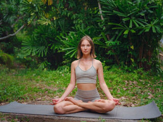 Beautiful woman practices yoga in Crabi, Thailand