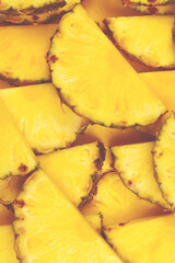 Pineapple juicy yellow slices background. Top view.