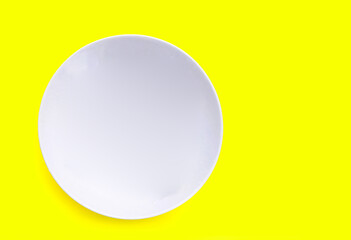 White plate on yellow background