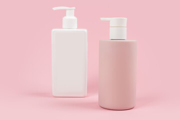 pink and white dispenser bottles on pink background, cosmetic packaging mockup with copy space