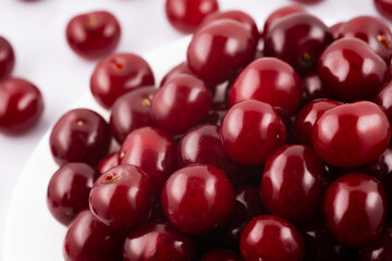 Fresh red cherries fruit on white background close up