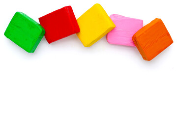 Colorful plasticine clay on white background.