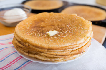 stack of appetizing flour pancakes in the kitchen during cooking
