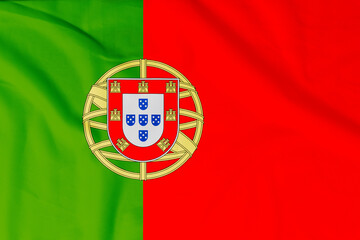 Flag of Portugal (Portuguese Republic) with natural material creases as a background