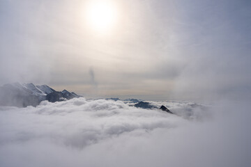 View of Swiss Alps over clouds on a bright sunny day from Schilthorn summit in Switzerland