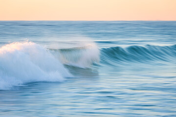 Breaking wave in motion at the beach.