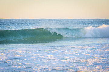 Clean small wave breaking at the beach.