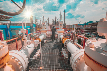 Male worker inspection at steel long pipes and pipe elbow in station oil factory during refinery...