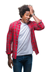 Afro american man over isolated background surprised with hand on head for mistake, remember error....