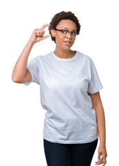 Fototapeta premium Beautiful young african american woman wearing glasses over isolated background smiling and confident gesturing with hand doing size sign with fingers while looking and the camera. Measure concept.