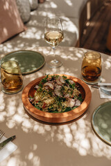 Healthy Mediterranean dishes at an open-air cafe table.