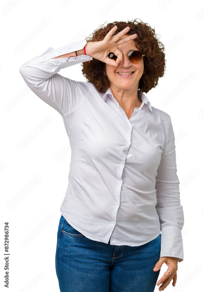 Canvas Prints Beautiful middle ager senior business woman wearing sunglasses over isolated background doing ok gesture with hand smiling, eye looking through fingers with happy face.