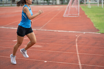 Obraz premium Asia mature woman Runner drill training on race track and field 