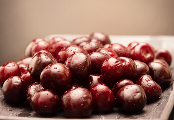 juicy, delicious cherries in a splash of water on a dark background.