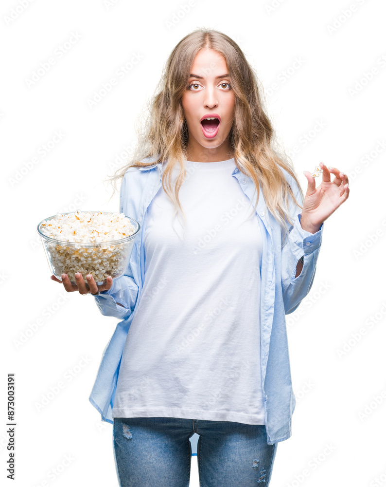 Canvas Prints Beautiful young blonde woman eating popcorn over isolated background scared in shock with a surprise face, afraid and excited with fear expression