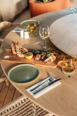 Shrimps grilled, prawns served with lime and sauce on a restaurant table wooden. Seafood.