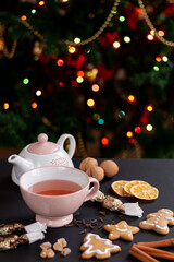 Cup of tea with Christmas cookies, walnut, cinnamon, and hungarian christmas candy and gingerbread.