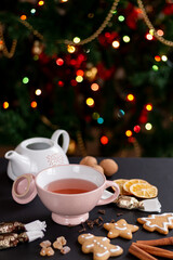 Cup of tea with Christmas cookies, cinnamon, and hungarian christmas candy, and walnut.
