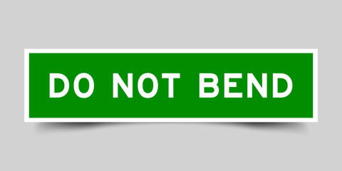 Green color square label sticker with word do not bend that inserted in gray background